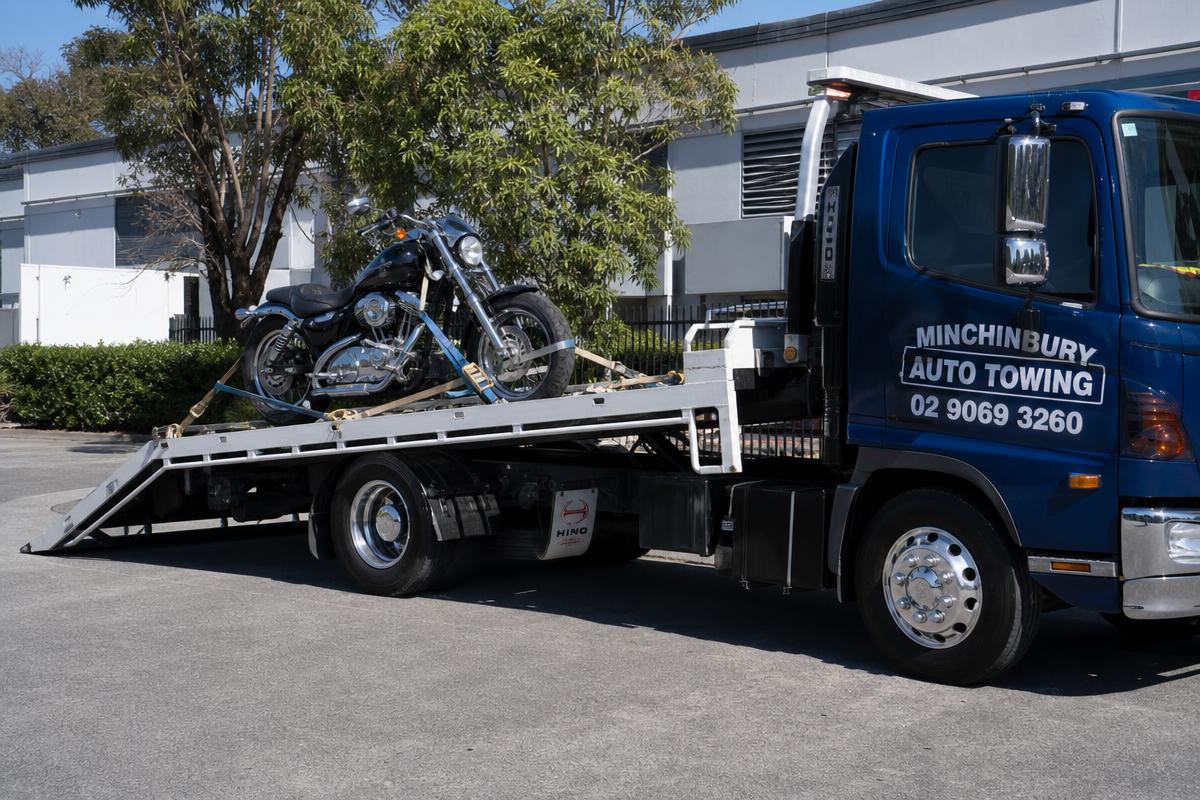 Motorbike strapped to a Minchinbury Auto Towing tilt tray truck